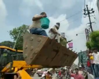 Pappu Yadav climbs JCB machine