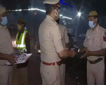 Delhi Police Commissioner Rakesh Asthana distributes sweets among personnel on night duty