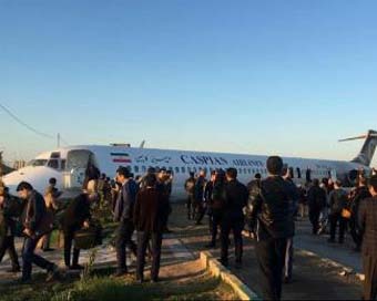 Iranian plane skids off runway into highway