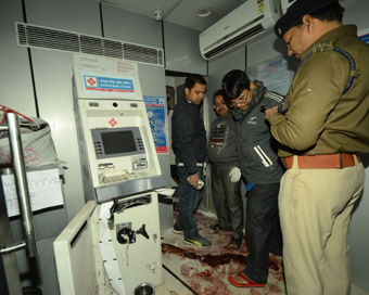 Patna: Patna: Police personnel inspects a crime scene and collects material evidence where Deepak Kumar, the security guard of a Central Bank ATM booth was killed by unidentified people in Patna on Dec 10, 2016. (Photo: IANS)