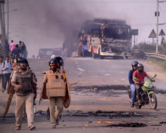 Howrah: Police personnel patrol a street after violence broke out as angry protesters burnt vehicles during a demonstration against the Citizenship Amendment Act (CAA) 2019, in West Bengal