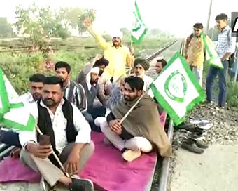 Protesters sitting on railway tracks