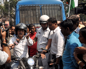 Kolkata: Security personnel detain BJP workers who took out a bike rally ahead of the Lok Sabha polls, in Kolkata.