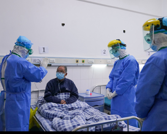 Doctors encourage a patient during making ward rounds in Zhangzhou Municipal Hospital in Zhangzhou,