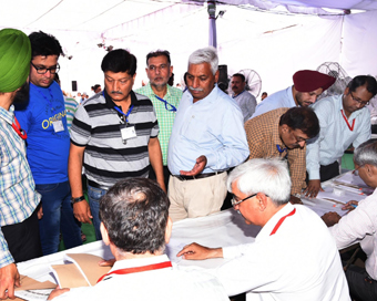 Chandigarh: Polling officials collect EVMs and other necessary inputs at a distribution center before leaving for their respective polling stations on the eve of the final phase of 2019 Lok Sabha elections, in Chandigarh on May 18, 2019. (Photo: IANS
