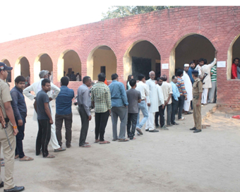 Gurugram: Voters queue-up to cast their votes for Haryana Assembly elections, at a polling station in Gurugram on Oct 21, 2019. (Photo: IANS)