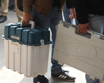 New Delhi: Polling officials carrying the Electronic Voting Machine (EVMs) and other necessary inputs required for the Delhi Assembly Election at a distributions centre in New Delhi on Feb 07, 2020. (Photo: IANS)