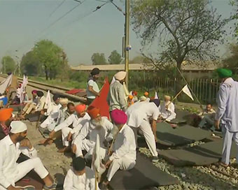  Farmers sitting on railway tracks