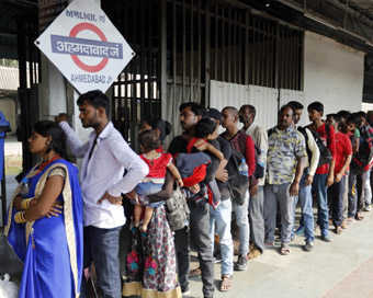 Ahmedabad: Migrant workers from Uttar Pradesh and Bihar wait to board a train as they leave for their homes, at Ahmedabad Junction railway station in the wake of reported violence against migrants from the two states; on Oct 9, 2018. Violence against