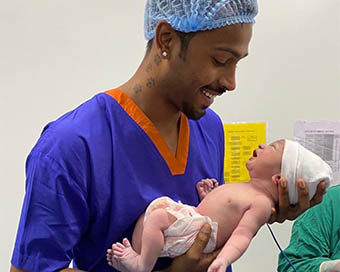 India all-rounder Hardik Pandya holding his newly-born baby