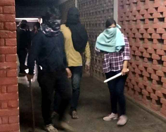 New Delhi: Students roam around the JNU hostel with rods and sticks after clashes erupted between groups of students at JNU campus in New Delhi on Jan 5, 2020. (Photo: IANS)