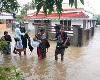 Kochi: People shift from a flood-hit locality in Kochi on Wednesday, Aug 15, 2018. The Cochin International Airport at Nedumbassery reportedly suspended operations till Saturday due to rains and floods.