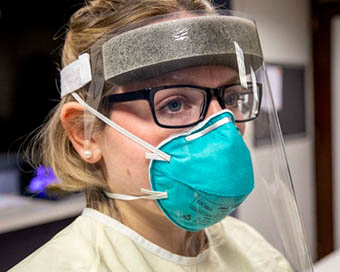 Woman in face shield and mask (file photo)