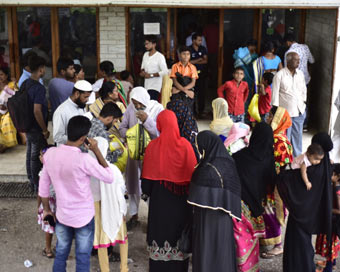 People wait outside the NRC hearing centre in Guwahati, on May 7, 2019. The complete draft published in July 2018 had excluded 40.07 lakh of the 3.29 crore applicants. (Photo: IANS)