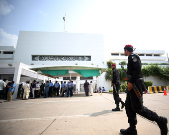 ISLAMABAD: Pakistani policemen walk past the National Assembly building during the presidential election in Islamabad, capital of Pakistan on Sept. 4, 2018. Polling for presidential election kicked off Tuesday in Pakistan with three candidates compet