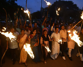 Patna: RJD workers participate in a torch march to protest against hike in fuel prices in Patna. 