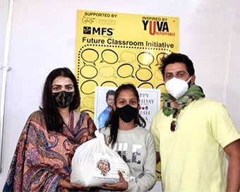 Suresh Raina and his wife Priyanka with a student