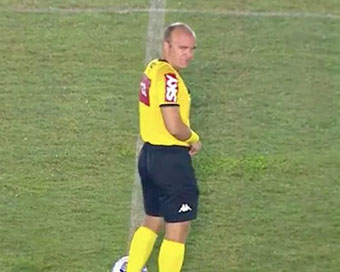 Football referee caught urinating in centre of the pitch seconds before kickoff on live TV
