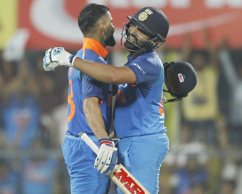 Guwahati: Indian captain Virat Kohli celebrates his century with teammate Rohit Sharma during the first ODI (One Day International) match between India and West Indies at the Barsapara Cricket Stadium in Guwahati.