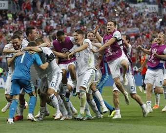 Moscow :  Russian teammates rush to hug and congratulate Russia goalkeeper Igor Akinfeev, left after he makes the a save during a penalty shoot out that send Russia to the quarterfinals during the round of 16 match between Spain and Russia at the 201