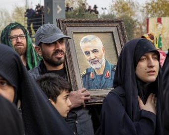 TEHRAN, Jan. 3, 2020 (Xinhua) -- A man holds a picture of top Iranian commander Qasem Soleimani during a protest in Tehran, Iran, on Jan. 3, 2020. An attack near Baghdad International Airport on Friday has killed top Iranian commander Qasem Soleimani