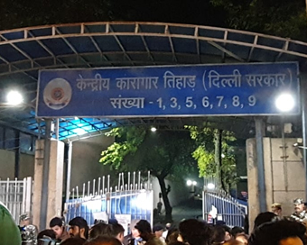 New Delhi: People hold posters outside the Tihar Jail ahead of the hanging of four convicts in the 2012 Nirbhaya rape case, in New Delhi on March 20, 2020. (Photo: IANS)