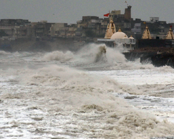 Porbandar: High waves lash the coast as Cyclone Vayu moves north-westwards skirting the Saurashtra coast in Gujarat while heavy rains have started lashing the coastal areas of the state, in Porbandar on June 13, 2019. As was feared, the 